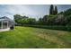 The lush backyard features a verdant lawn, trimmed hedges, and a partially enclosed patio at 2143 Edelweiss Loop, Trinity, FL 34655