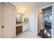 Hallway dressing area features ample lighting and a view into the main bedroom at 2143 Edelweiss Loop, Trinity, FL 34655