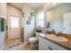 Bathroom featuring a shower, vanity, window and door to the exterior at 2143 Edelweiss Loop, Trinity, FL 34655