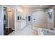 Bathroom featuring tile flooring, a vanity with ample lighting, and a glass enclosed shower at 2143 Edelweiss Loop, Trinity, FL 34655