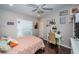 Cozy bedroom with a large window, wood floors, ceiling fan and a vanity at 2143 Edelweiss Loop, Trinity, FL 34655