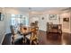 Dining room featuring hardwood floors, classic furnishings, and an open layout at 2143 Edelweiss Loop, Trinity, FL 34655
