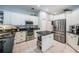 Well-equipped kitchen with stainless steel appliances, white cabinets, and a center island at 2143 Edelweiss Loop, Trinity, FL 34655