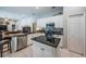 Spacious kitchen with granite countertops, stainless appliances, and a view into the living area at 2143 Edelweiss Loop, Trinity, FL 34655