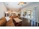 Spacious living room with dark hardwood floors, opens to a white kitchen and screened in porch at 2143 Edelweiss Loop, Trinity, FL 34655