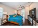 Bright main bedroom features a ceiling fan and sliding glass doors to the pool area at 2143 Edelweiss Loop, Trinity, FL 34655