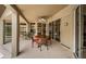 Covered outdoor patio features sliding glass doors to the interior and furniture for dining or relaxing at 2143 Edelweiss Loop, Trinity, FL 34655