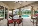 Covered patio dining area with an outdoor grill overlooks a screened-in pool for easy outdoor living at 2143 Edelweiss Loop, Trinity, FL 34655