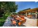 Charming outdoor picnic area with wooden tables and benches surrounded by lush landscaping for community enjoyment at 2143 Edelweiss Loop, Trinity, FL 34655
