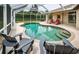Enjoy the screened-in pool and patio area, surrounded by lush landscaping and comfortable seating at 2143 Edelweiss Loop, Trinity, FL 34655