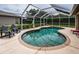 Relax by the screened pool with sun loungers and mature landscaping for privacy at 2143 Edelweiss Loop, Trinity, FL 34655