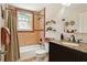 Bathroom featuring patterned tile shower and dark wood vanity at 2511 W Morrison Ave, Tampa, FL 33629