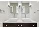 Bathroom with dual sinks, modern fixtures, and decorative wall tiling at 2511 W Morrison Ave, Tampa, FL 33629