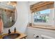This charming bathroom features a wood countertop, round mirror and modern fixtures at 2511 W Morrison Ave, Tampa, FL 33629