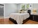 Bedroom featuring hardwood floors, a queen-sized bed, and view to backyard at 2511 W Morrison Ave, Tampa, FL 33629