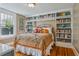 Bedroom featuring built-in bookshelves and a cozy aesthetic at 2511 W Morrison Ave, Tampa, FL 33629