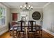 Elegant dining room with a rustic wooden table, chandelier, and view to the living room at 2511 W Morrison Ave, Tampa, FL 33629