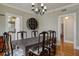 Bright dining room with hardwood floors, unique shelving, and an adjoining kitchen at 2511 W Morrison Ave, Tampa, FL 33629
