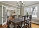 Stylish dining room showcasing a large wooden table, French doors, and hardwood floors at 2511 W Morrison Ave, Tampa, FL 33629