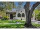 Stunning home showing stucco exterior, arched windows, beautiful greenery, and brick walkway at 2511 W Morrison Ave, Tampa, FL 33629