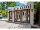 Charming outdoor pool house featuring a blue and white awning and rustic brick paving at 2511 W Morrison Ave, Tampa, FL 33629