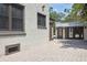 Exterior view showcasing a home with brick paving, and a charming pool house with awning at 2511 W Morrison Ave, Tampa, FL 33629
