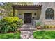 Inviting front porch with tile steps, iron railings, and a dark wood door with address numbers above at 2511 W Morrison Ave, Tampa, FL 33629
