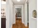 Hallway showcasing hardwood floors and access to various rooms at 2511 W Morrison Ave, Tampa, FL 33629