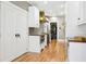 Bright kitchen featuring white cabinets, wood countertops, colorful backsplash, and stainless steel appliances at 2511 W Morrison Ave, Tampa, FL 33629