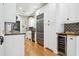 Bright kitchen featuring white cabinets, wood countertops, colorful backsplash, and stainless steel appliances at 2511 W Morrison Ave, Tampa, FL 33629