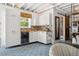 Features a small kitchenette with modern appliances, cabinetry, and unique backsplash at 2511 W Morrison Ave, Tampa, FL 33629