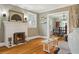 Warm living room with fireplace, hardwood floors, and view to dining room at 2511 W Morrison Ave, Tampa, FL 33629