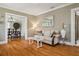 Inviting living room featuring hardwood floors, a comfortable sofa, and a view into the dining room at 2511 W Morrison Ave, Tampa, FL 33629