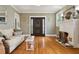 Cozy living room with hardwood floors, fireplace, and a large front door at 2511 W Morrison Ave, Tampa, FL 33629