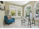 Office featuring arched windows, tiled floors, glass table and a comfortable accent chair at 2511 W Morrison Ave, Tampa, FL 33629