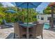 Outdoor dining area with a table, chairs, and lush tropical landscaping at 2511 W Morrison Ave, Tampa, FL 33629