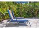 Comfortable patio lounge chairs with colorful cushions surrounded by lush landscaping at 2511 W Morrison Ave, Tampa, FL 33629