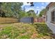 Spacious backyard with shed, partial fence, and lush greenery, perfect for outdoor activities at 2646 61St N Ave, St Petersburg, FL 33714
