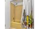 Bathroom featuring a bathtub with a yellow tile surround and a cactus shower curtain at 2646 61St N Ave, St Petersburg, FL 33714