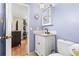 Charming blue bathroom with an updated vanity, toilet, and a view into another room at 2646 61St N Ave, St Petersburg, FL 33714