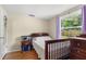 Bedroom with wood floors, natural light, and a view of the green fenced backyard at 2646 61St N Ave, St Petersburg, FL 33714