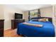 Cozy bedroom with a comfortable blue bed, a dresser, and natural light from the window at 2646 61St N Ave, St Petersburg, FL 33714