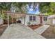 Charming single-story home with a carport, stone accents, and a well-manicured front yard at 2646 61St N Ave, St Petersburg, FL 33714