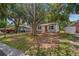 Beautiful home exterior featuring mature trees, a long driveway, and well-kept landscaping at 2646 61St N Ave, St Petersburg, FL 33714
