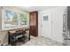 Bright kitchen featuring wooden cabinets, tiled floor, stainless steel fridge and dining area at 2646 61St N Ave, St Petersburg, FL 33714