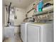 Spacious laundry room with washer, dryer, utility sink, and storage shelving at 2646 61St N Ave, St Petersburg, FL 33714