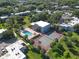 An aerial view shows a pool, clubhouse, and tennis court surrounded by green spaces and palm trees at 2820 Somerset Park Dr # 101, Tampa, FL 33613