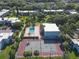 View of community amenities including a pool, clubhouse, and tennis court surrounded by lush landscaping and palm trees at 2820 Somerset Park Dr # 101, Tampa, FL 33613
