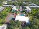 Aerial view of apartments with amenities including a pool, tennis court, clubhouse, and ample parking at 2820 Somerset Park Dr # 101, Tampa, FL 33613
