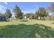 Lush green backyard featuring mature trees, providing shade and a serene outdoor space at 2820 Somerset Park Dr # 101, Tampa, FL 33613